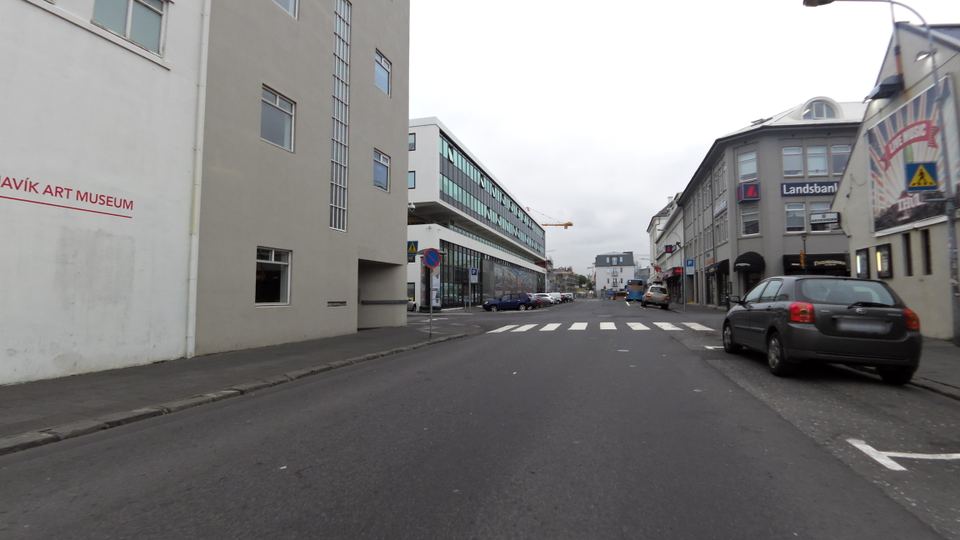 A street with buildings and parked cars in Reykjavik