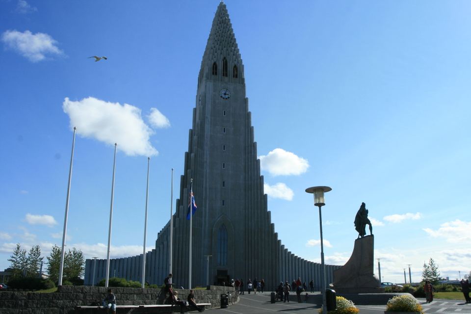 Hallgrímskirkja church standing tall against a blue sky with light clouds in Reykjavik