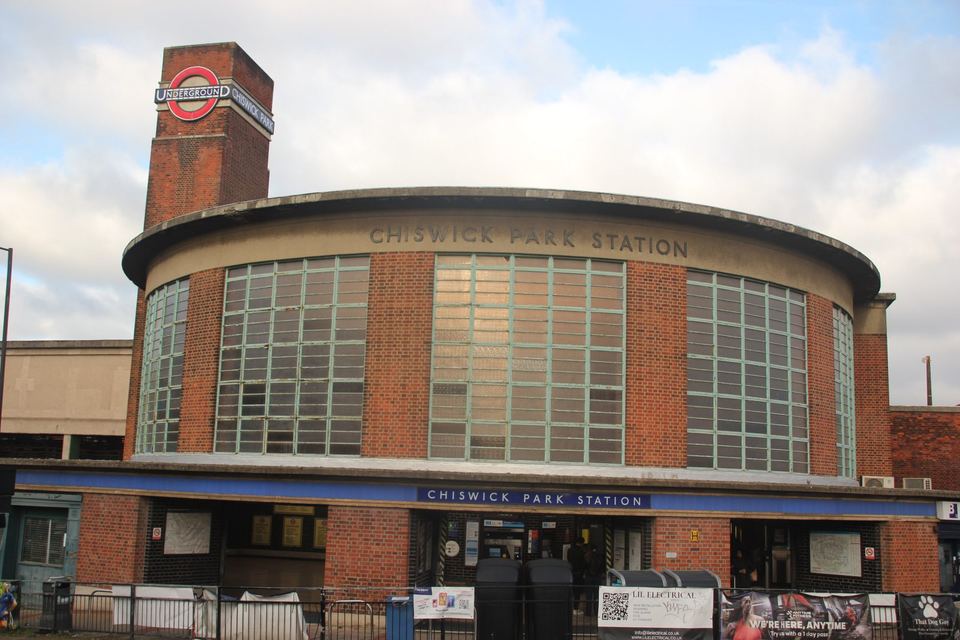 Front view of the curved brick facade of Chiswick Park station
