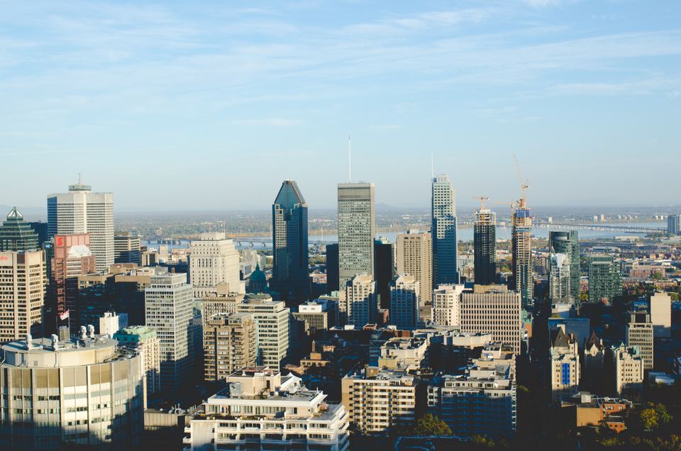 Panoramic high angle view of downtown Montreal skyscrapers under a clear blue sky