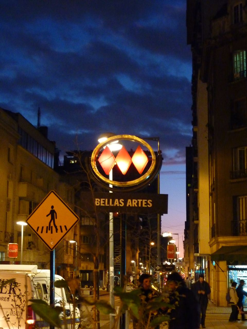 Illuminated Bellas Artes metro sign on a street at dusk in Santiago