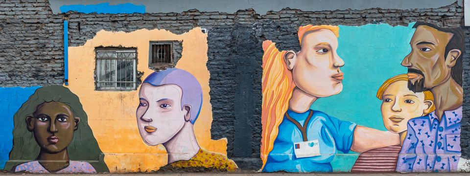 Colorful street art mural painted on an exposed brick wall