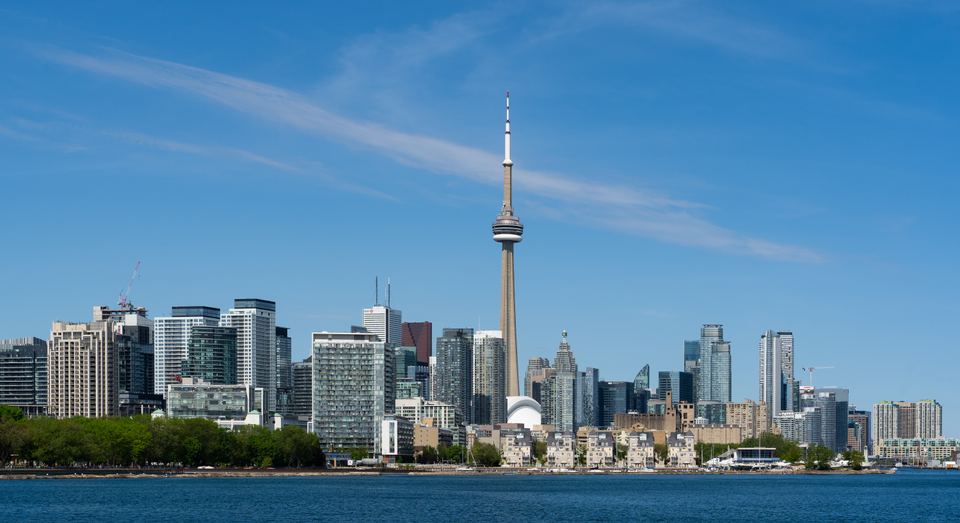 Wide panoramic photograph of the downtown Toronto skyline along the water