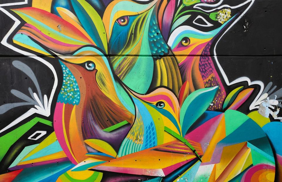 A large colourful bird mural painted on a wall in Comuna 13, Medellin