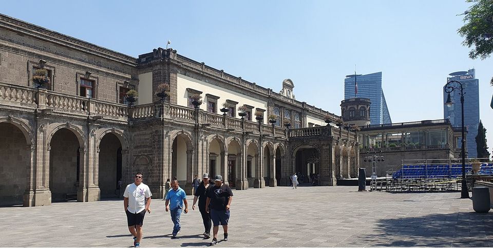 The main facade of Chapultepec Castle with visitors on the forecourt