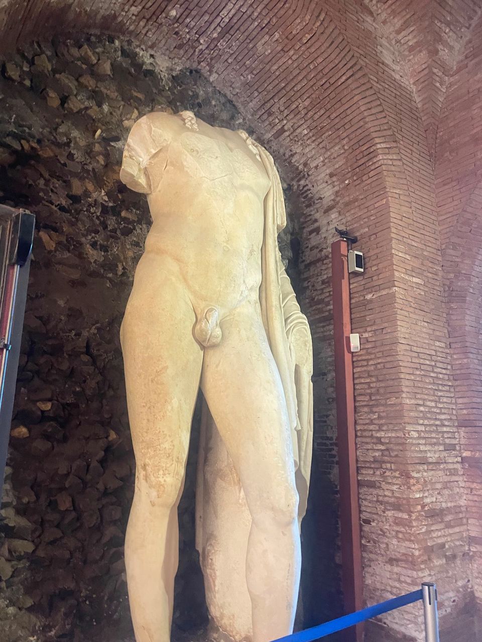 ancient statue in brick archway