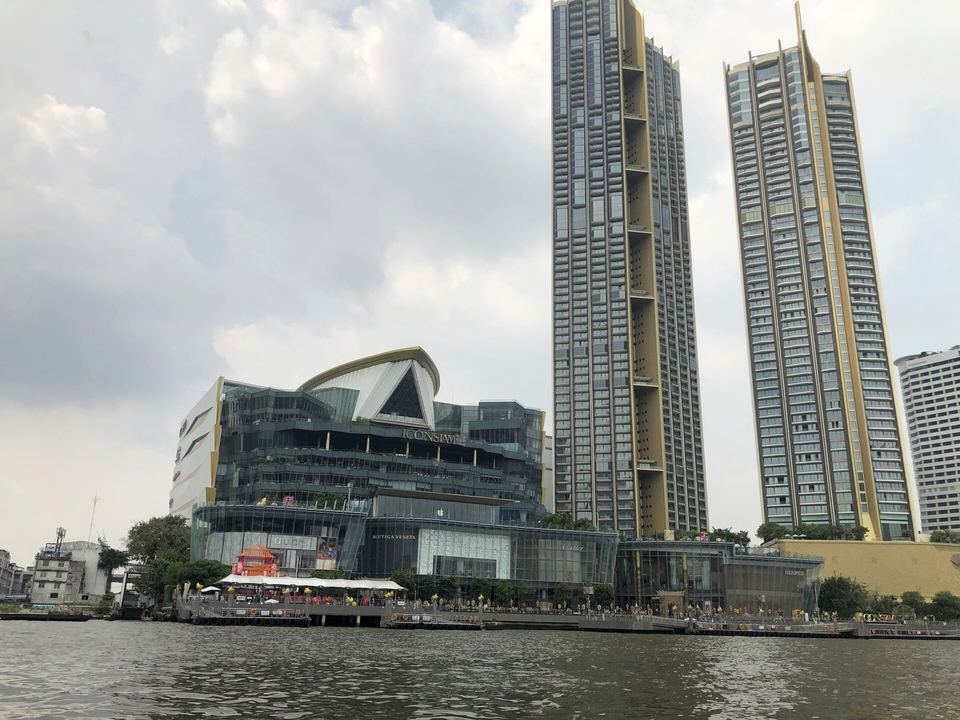 The Iconsiam complex and its towers on the Chao Phraya riverbank, seen from an approaching boat
