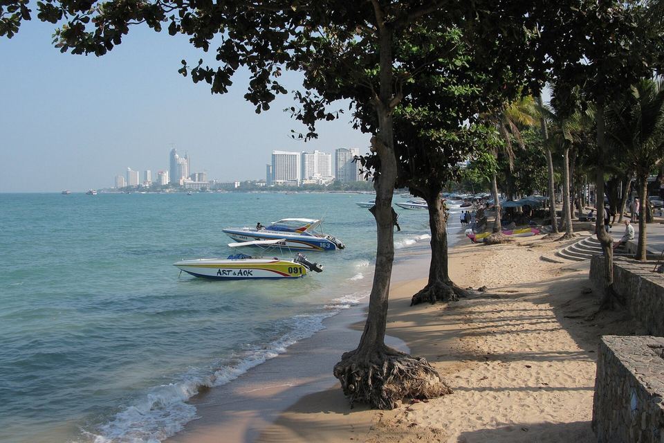 Pattaya Beach seen from the shaded promenade, with speedboats moored in the bay