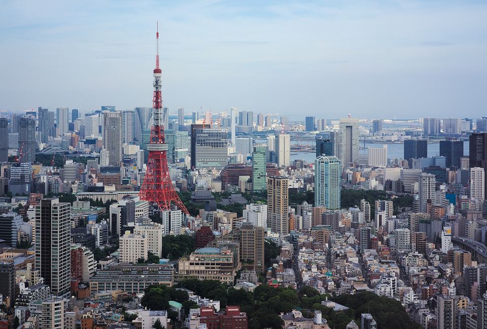High-angle view of Tokyo skyline with Tokyo Tower visible among high-rise buildings.